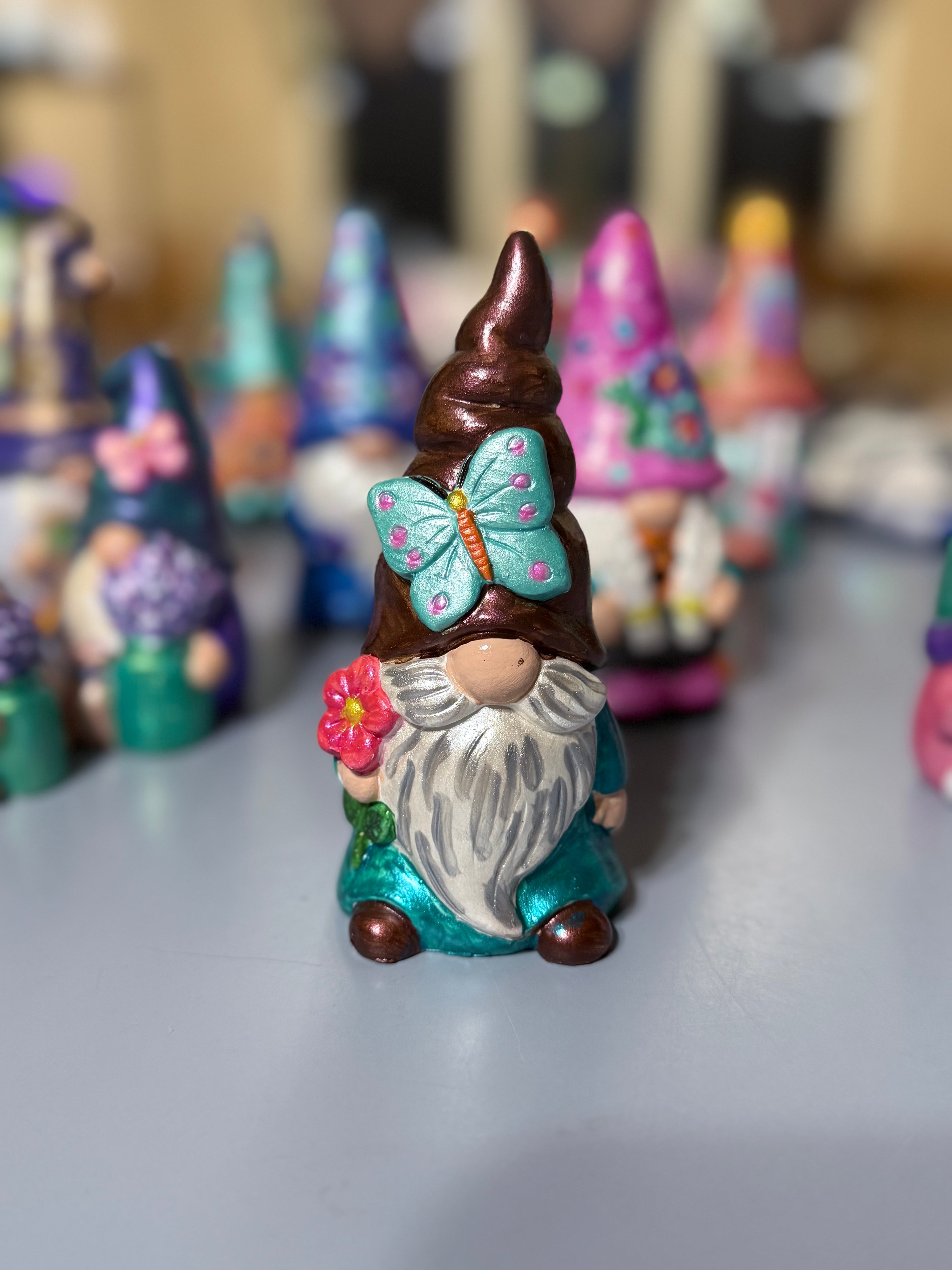 Catching Butterflies with the Gnome with bright vibrant colors and adorned with metallic paint to shimmer