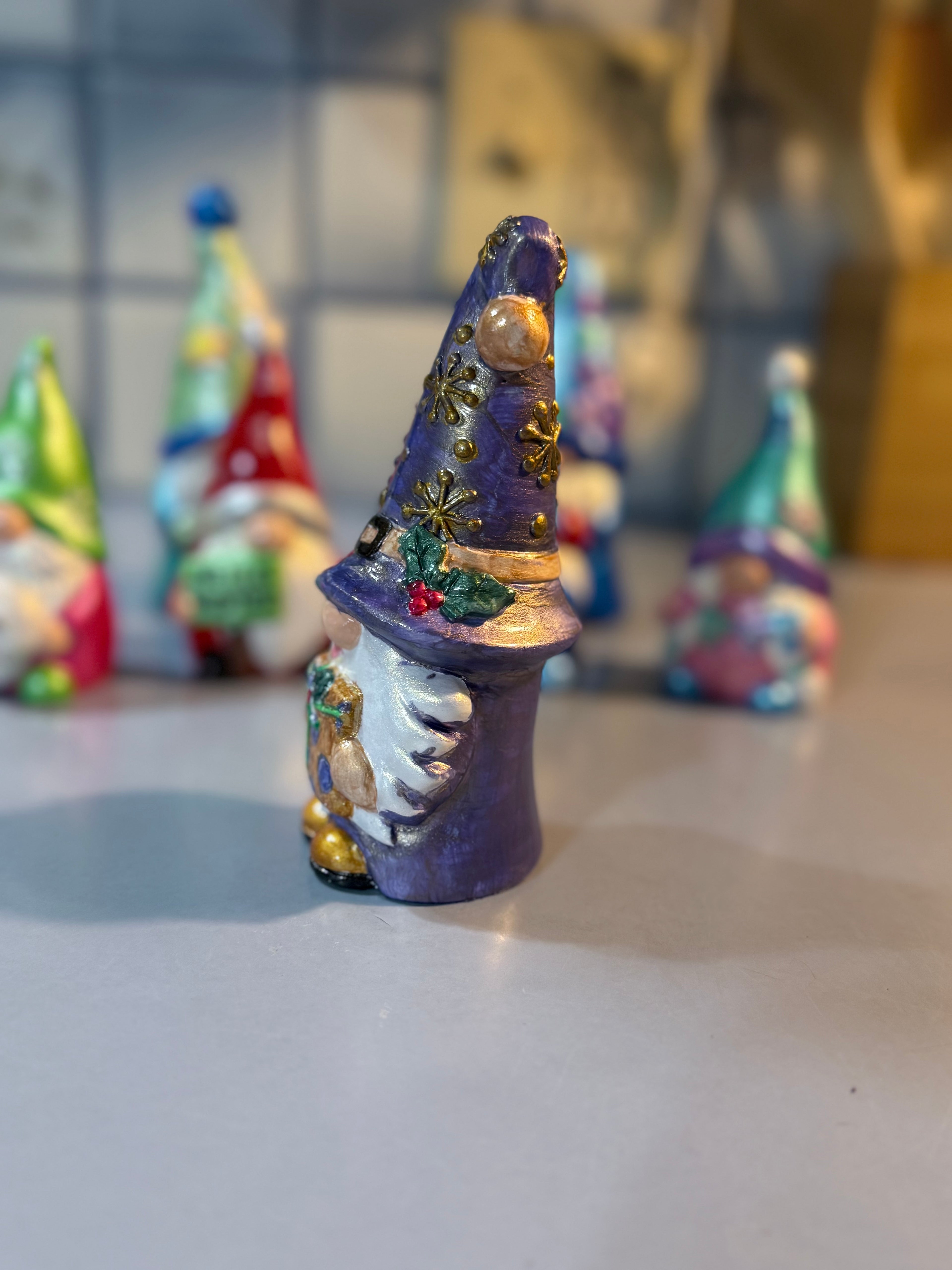 Whimsical Christmas Gnome intricately hand painted with shades of metallic and iridescent color and some iridescent glitter for shimmer ￼￼￼